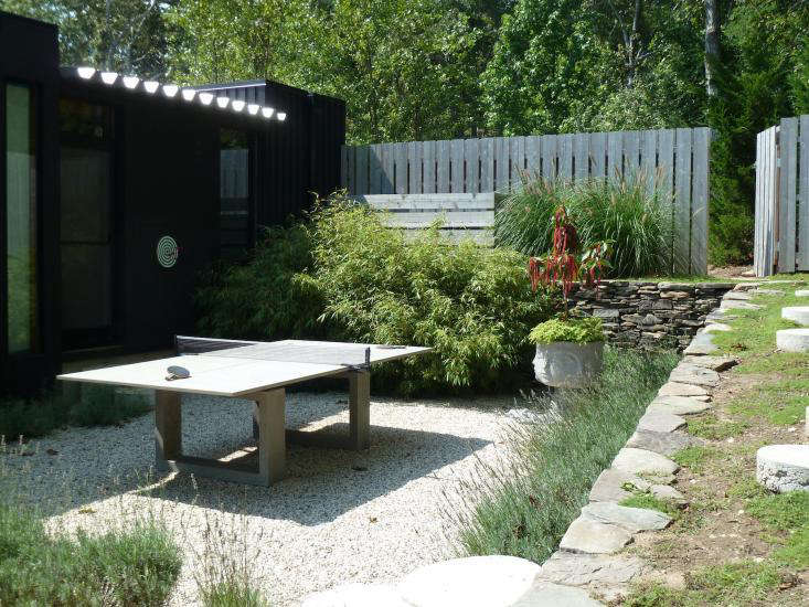 A cluster of bamboo grows next to the ping pong table in Jonathan Adler and Simon Doonan